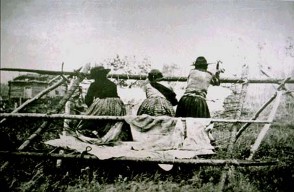 Three Stoney Women on the Morley Reserve in Canada scraping a hide