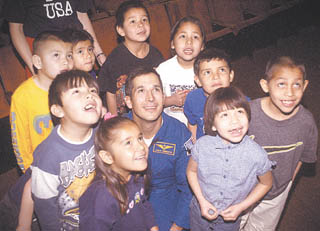 NASA astronaut John Herrington, center poses for a photograph Tuesday with kindergarten students at Lodge Grass School. 