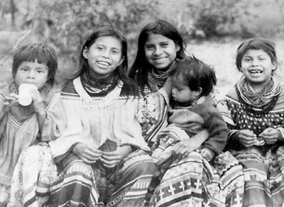 Young Miccosukee children dress in traditional wear and await their next day in school.