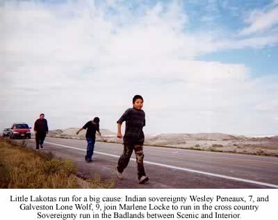 Little Lakotas run for a big cause: Indian sovereignty Wesley Peneaux, 7, and Galveston Lone Wolf, 9, join Marlene Locke to run in the cross country Sovereignty run in the Badlands between Scenic and Interior. Photo Brenda Norrell