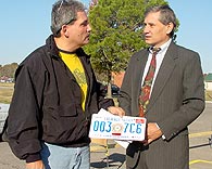Jack Jackson, Cherokee Nation citizen from Kansas, Okla., talks with Principal Chief Chad Smith and displays the first Cherokee Nation car tag sold, which Jackson purchased in October, 2001.
