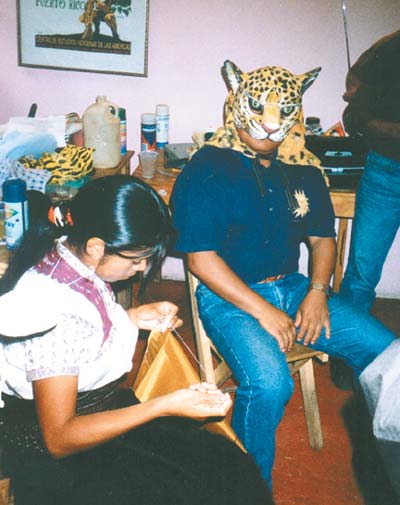 Writer Diego Méndez Guzmán models a jaguar mask at House of the Writer headquarters in San Cristóbal, Mexico. (Photo courtesy Phillip Burnham.)