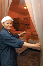 Rosie Mosesee, the plant's floor manger, at one of three walk-in freezers.