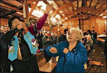 Bringing down the house, or in this case the longhouse, are elder Pauline Flett (Spokane Tribe) and Wilson Wewa (Northern Payute) in a spontaneous dance to the beat of Skokomish tribal drummers. After the dinner, Indians came forward, tribe by tribe, to offer songs and dances. Some danced barefoot in rolled-up jeans, some wore button blankets and other tribal regalia. 