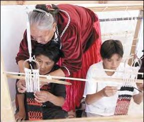 Sandra Black, 65, of Promise Rock, Utah, teaches about weaving. 