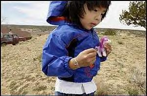Sierra Chopito, 4, juggles a pink pony and purple wildlfowers on the Navajo reservation near Gallup, New Mexico.