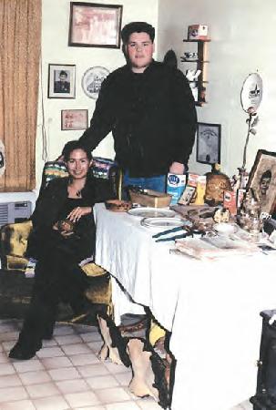 Mique’l Askren, 22 (sitting) and David Robert Boxley, 21, in their home surrounded by Boxley’s grandparents’ memorabilia. (Photo by Matt Ross.)