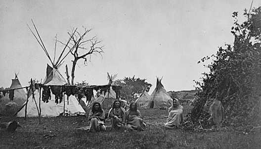 Arapaho camp with buffalo meat drying Kansas, 1870