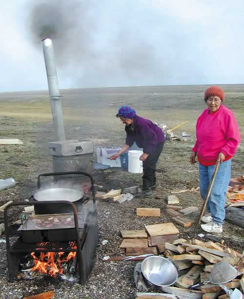 COOKING ALL DAY—Erma Hunnicutt and Rosella Stone cooked the meat on open fire stoves. 