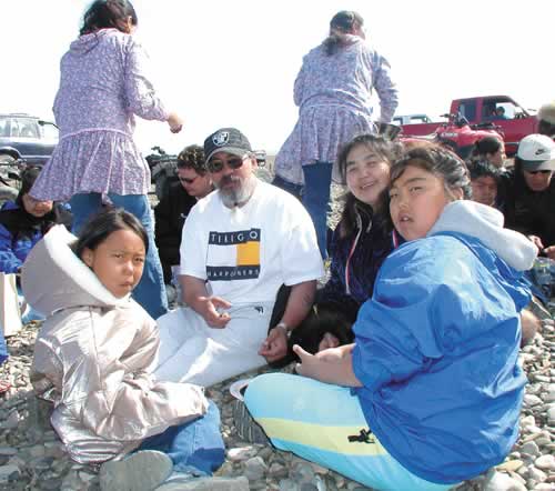 PICNIC ON THE BEACH - Point Hope Mayor Martin Oktollik, his wife Carrie and granddaughters Emily (left) and Lilliann (right). Oktollik instills a sense of tradition and understanding of their ways to the young girls. (Photo by Amy Flaherty) 
