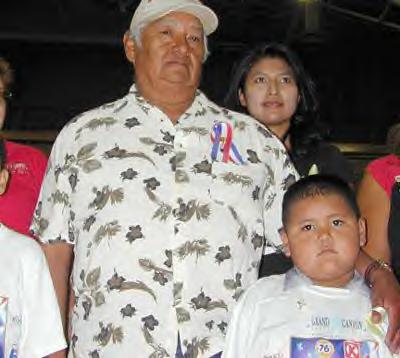 Lori Piestewa's father, Terry Piestewa and her son, Brandon Whiterock, 5 are feted during the opening ceremonies of the Lori Piestewa National Native American Games in Flagstaff, Ariz.