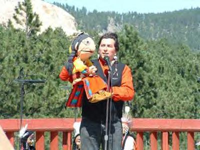 Iron Horse, left, and his assistant Buddy Big Mountain entertain a crowd. (David Melmer Indian Country Today)