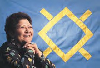 Northern Cheyenne Tribal Chairwoman Geri Small is shown with the tribal flag and its distinctive Morning Star symbol.