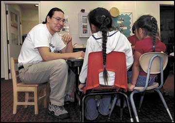 Joshua Brown chats with sisters Siliye, center, and Susseli Pete at the Salish language immersion school in Arlee last week. Brown was recently awarded a 2003 Echoing Green fellowship worth $60,000 over two years to fund the Salish Language Perpetuation Project. Photo by Michael Gallacher/Missoulian