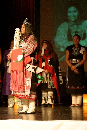 Cheryl V. Dixon listens to the honor song from the Star Feather Drum Group after being crowned Miss NCAI 2003.