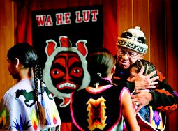 Where he once was embraced with handcuffs, Billy Frank Jr. is now embraced with hugs. The Nisqually Tribal elder greets children last month at Wa He Lut School in Nisqually, which stands near the place where Indians and police had a showdown in 1970 during the "fish wars" over Indian fishing rights