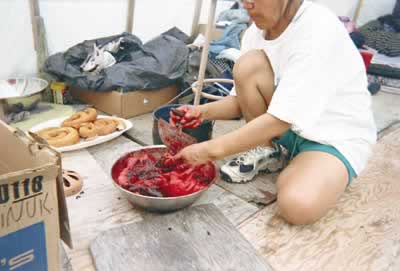 Visions Inuit 2004, photo by Tyna Amidlu - preparing meat.
