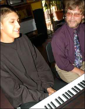Gideon TwoCrow sits at a piano with music instructor Howard Searle at Ignacio High School on Wednesday. "He learned on the ‘Moonlight Sonata.’ There are some crazy things that go on in that piece" Searle says. 