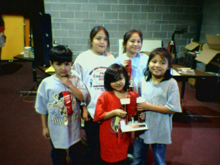 The Chess Team displays one of its trophies.