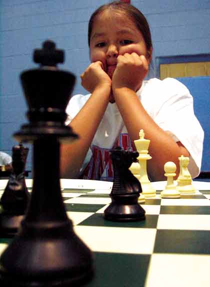 Pine Hill 5th grader Mathew Shepherd, 10, is in deep thought before making his move while playing chess against another member of the Pine Hill chess team before an awards banquet at Pine Hill High School May 19. (Times photo - Leigh T. Jimmie)