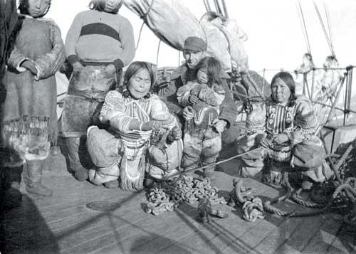 Over 80 years ago, on September 2, 1922, Ulaajuk and Nutaraarjuk stood near Qulittalik (kneeling), and photographer William H. Grant, holding Akpaliapik, next to a woman identified as Puttiuq in the Pond Inlet area. (PHOTO BY WILLIAM H. GRANT/COURTESY OF LIBRARY AND ARCHIVES CANADA)