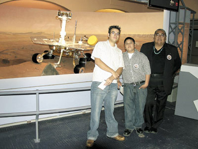 Students Mark Vallejos and Brandon Herrera along with teacher Joe Aragon, pose with a model of the Mars Exploration Rover at NASA’s Jet Propulsion Laboratory. (Photo courtesy Joe Aragon)