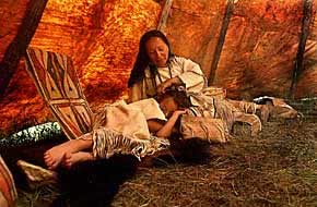 Daynetta Bald Eagle strokes the hair of her daughter, Brenna, 7, as the child naps on a buffalo rug in the family's tipi at Wicoti near Hill City. Wicoti is a living Lakota village reflecting American Indian life as it was in 1804, when Lewis and Clark passed through the region. (Dick Kettlewell, Journal staff) 