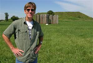 Archeologist Tim Pauketat in front of a reconstructed section of the stockade with Cahokia's biggest mound — a four-tiered pyramid known as Monks Mound — beyond. Jim Seida / MSNBC.com